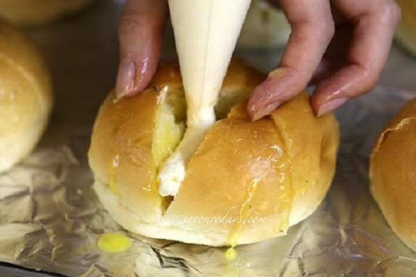 Bơm nhân kem phô mai béo ngậy vào từng rãnh bánh mì bơ tỏi