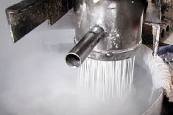 Ép sợi bún tươi từ khuôn vào nồi nước sôi
