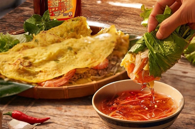 Gia đình cùng nhau thưởng thức bánh xèo nóng hổi, quây quần bên mâm cơm
