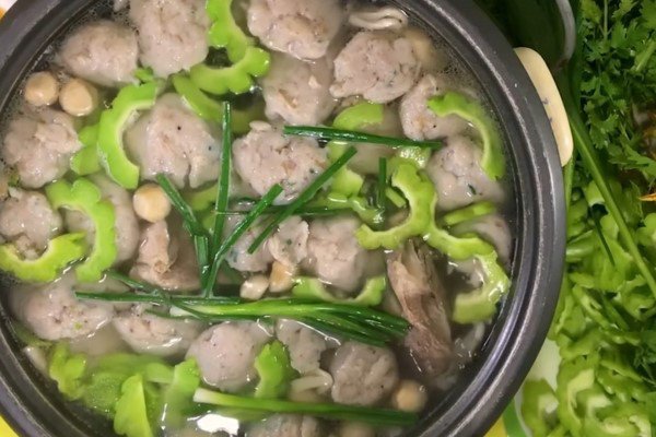 Những viên chả cá thác lác và lát khổ qua được thả vào nồi lẩu đang sôi