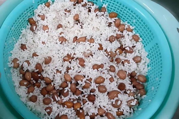 Trộn nếp với dầu ăn khi nấu xôi đậu phộng bằng nồi cơm điện
