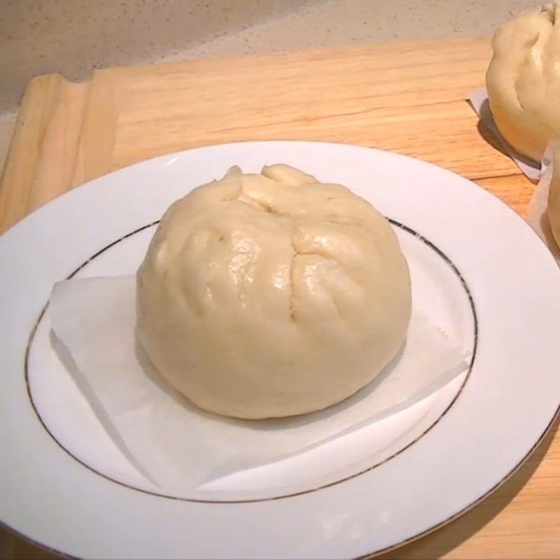 Bánh bao hấp chín, nở phồng, trắng mịn và thơm lừng, minh chứng cho cách làm bánh bao thành công.