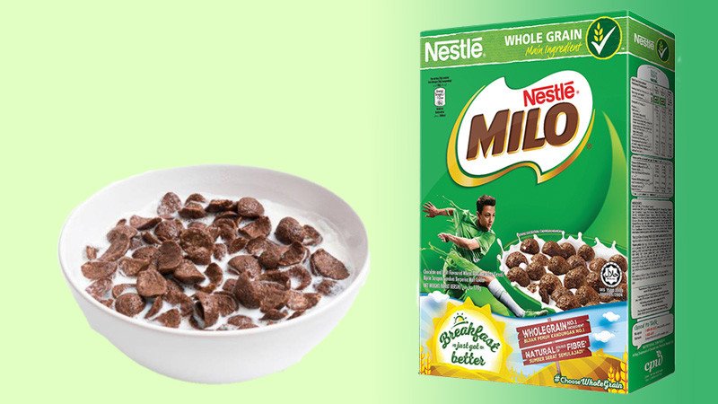 Chén ngũ cốc Milo đã chuẩn bị cùng hộp ngũ cốc nguyên bản, minh họa cho lựa chọn bữa sáng lành mạnh không lo tăng cân.