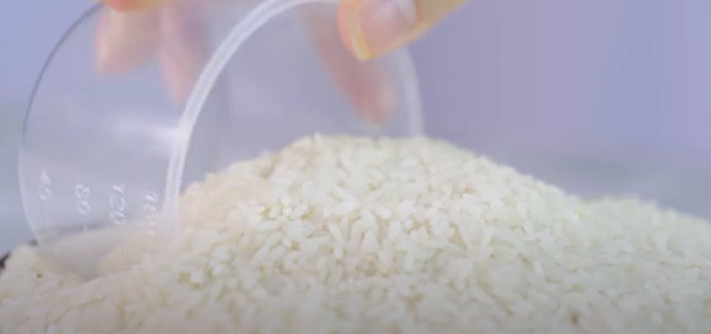 Đong nước nấu xôi sắn trong nồi cơm điện