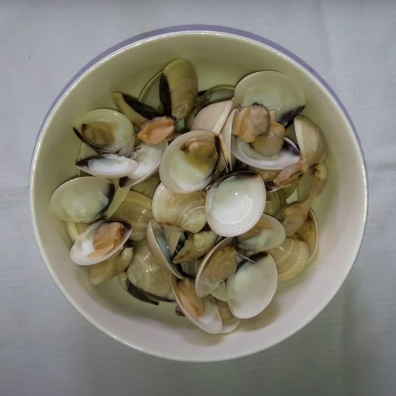 Luộc ngao trong nồi để tách lấy thịt và nước dùng ngọt cho canh mùng tơi