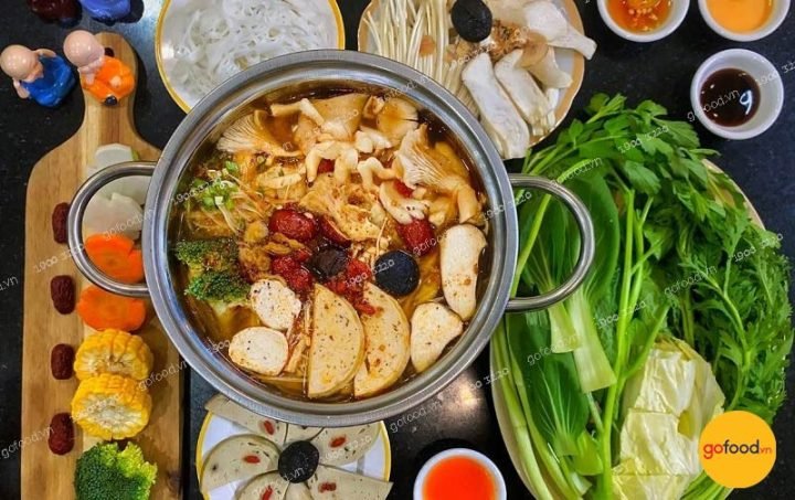 Mâm lẩu Thái chay với nhiều loại rau củ tươi ngon, nấm và tàu hũ ky, sẵn sàng để thưởng thức.