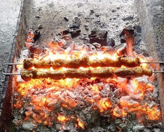 Món thịt chó nướng miền Bắc thơm lừng, vàng ruộm, sẵn sàng để thưởng thức cùng rau thơm