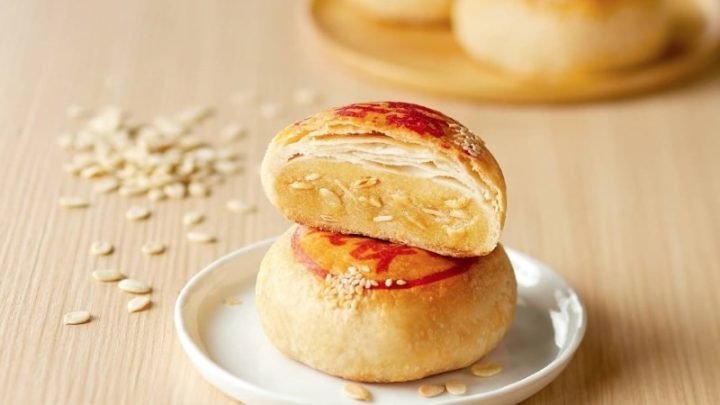 Một chiếc bánh pía truyền thống cắt lát, hiển thị nhân sầu riêng và trứng muối, tượng trưng cho năng lượng trong bánh pía.