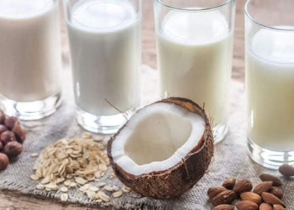 Nồi nước cốt dừa đang được đun trên bếp, chuẩn bị thêm bột năng để làm đặc