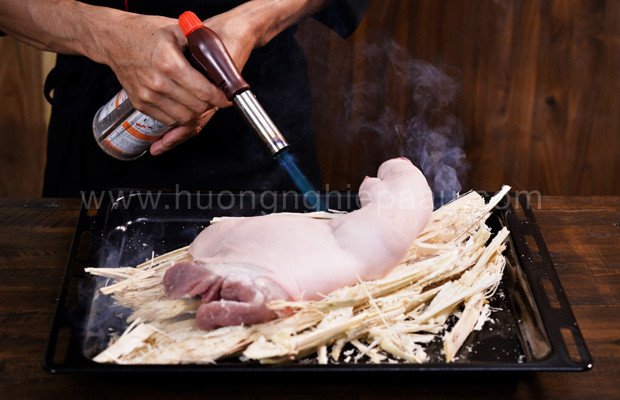 Sơ chế chân giò bằng cách hun khói bã mía để làm món thịt giả cầy chân giò thơm ngon
