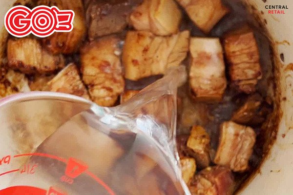 Thịt ba chỉ đang được kho liu riu cùng nước dừa tươi, chuẩn bị cho món thịt kho trứng đậm đà