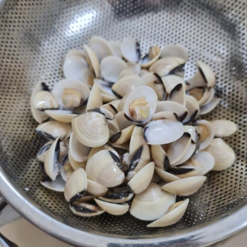 Thịt ngao đã tách vỏ và nước luộc ngao sạch sau khi sơ chế, sẵn sàng cho món canh ngao dứa cà chua