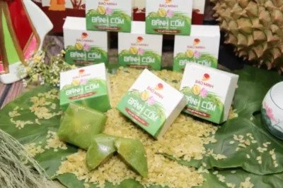 Người phụ nữ đang thưởng thức bánh cốm, gợi nhắc về việc kiểm soát khẩu phần để cân bằng dinh dưỡng và lượng calo bánh cốm.